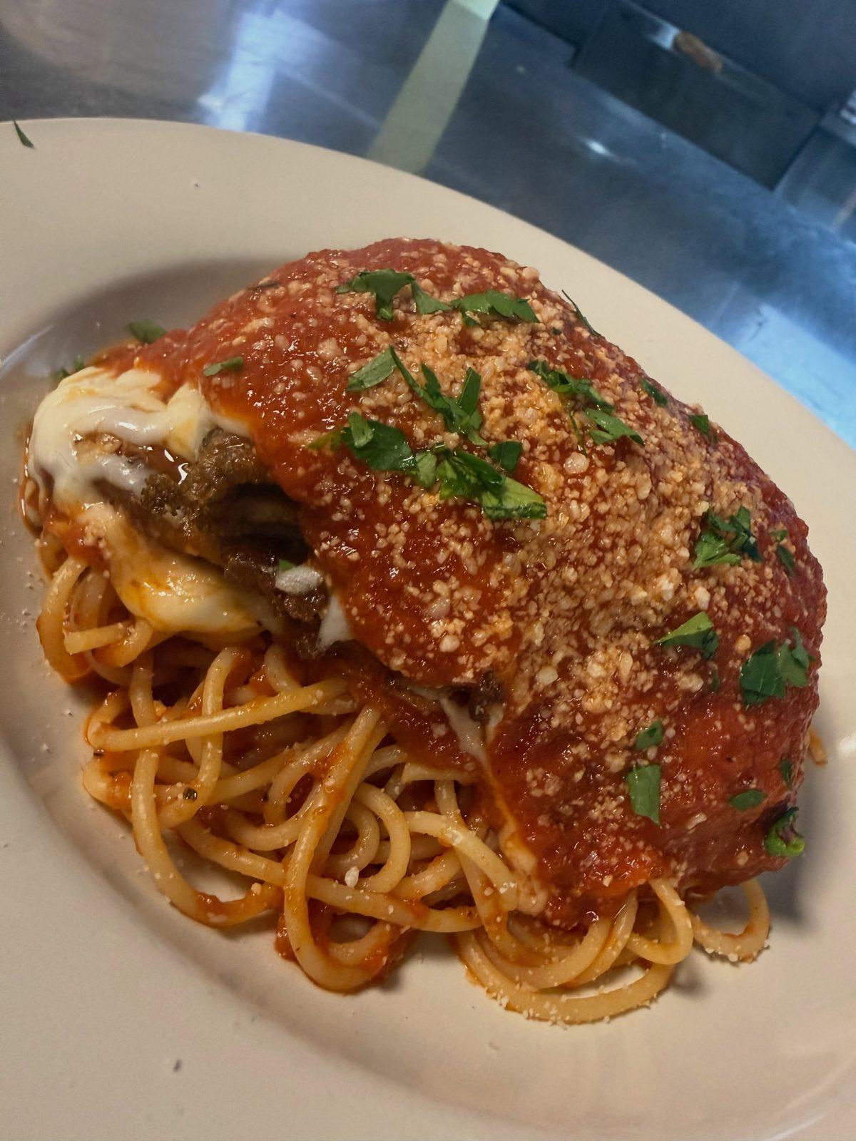 Parmigiana with melted cheese and marinara over spaghetti at Pizzeria DiMeo