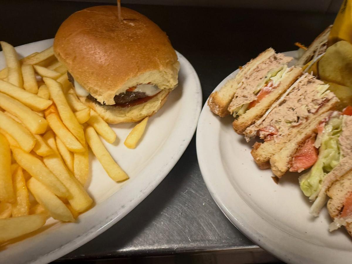 Cheeseburger with fries next to a club sandwich